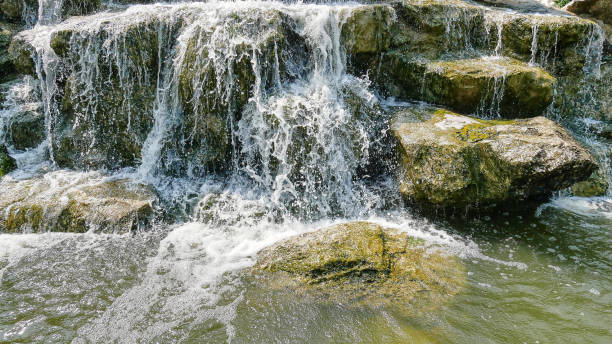 istock Tranquil Background of Waterfall and Small Rocks 1126718514
