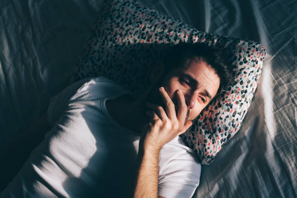 istock Young depressed man crying in bed 1126718669