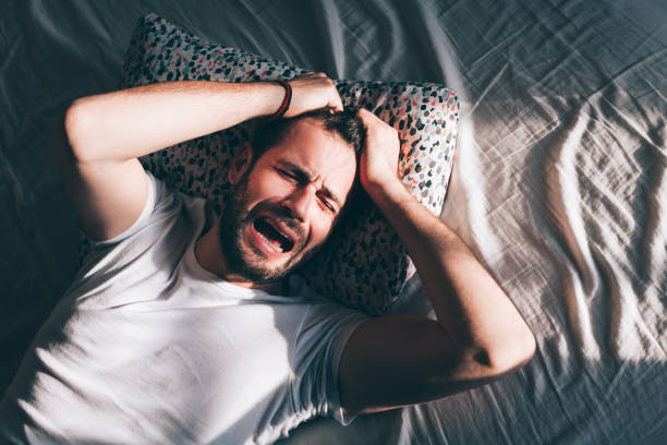 istock Young depressed man crying in bed 1126718680