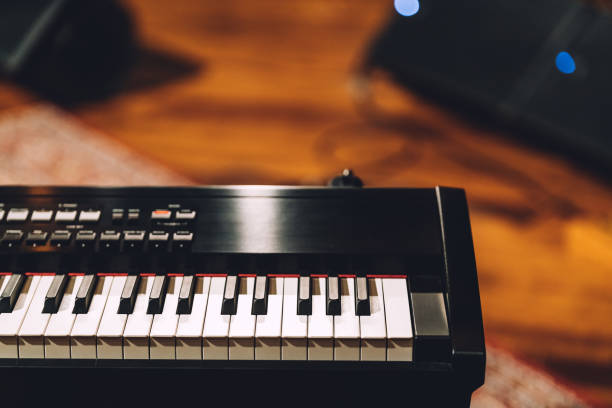istock Electronic musical keyboard synthesizer with white and black keys in recording studio. With copy space. 1126720095