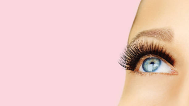 istock Opened female eye with long false eyelashes 1126724515