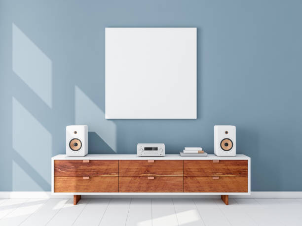 istock Square white canvas Mockup hanging on the Blue wall, hi fi micro system on bureau 1126725294