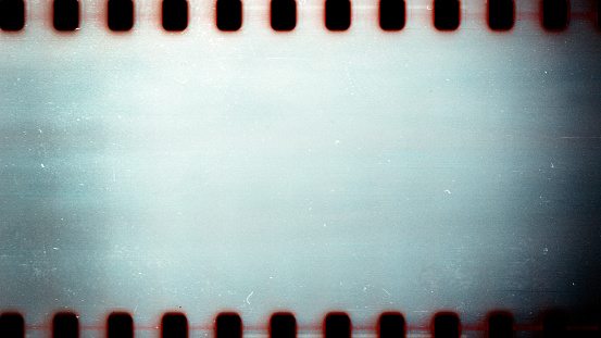 Blank grained film strip texture background with heavy grain dust and scratches