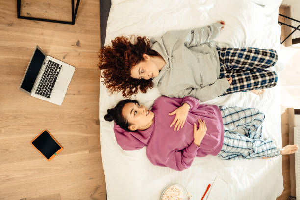 istock Two women looking lovely while wearing pajamas and talking 1126729523