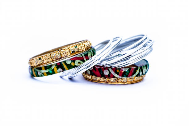 istock Close up of luxurious silver and gold bangles with diamonds on it isolated on white. 1126729698