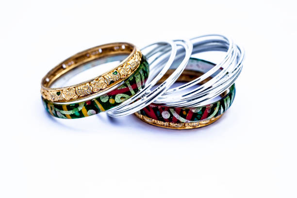 istock Close up of luxurious silver and gold bangles with diamonds on it isolated on white. 1126729699