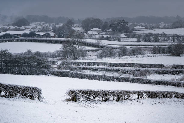 istock snow covered landscape looking over a valley with an open gate in the foreground 1126729768