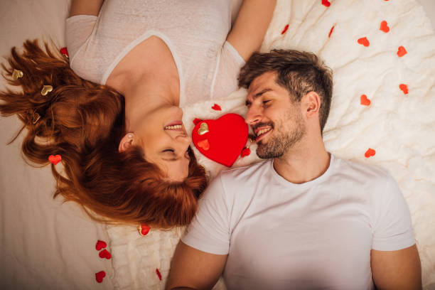 istock Couple lying on bed of roses 1126733170