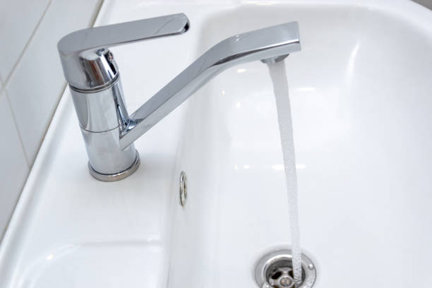 istock Dripping water from the single handle mixer tap mounted on a wash basin 1126736189