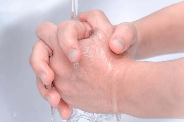 istock Washing hands with splashing and drops of water 1126736202