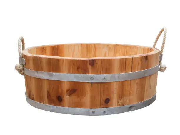 Flat wooden tub held by two steel hoops with hemp ropes as a handle isolated on white.