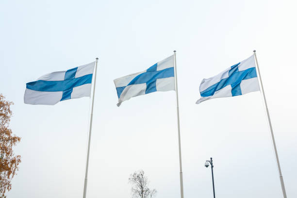 istock Three national flags of Finland on poles at wind and sky background 1126736367