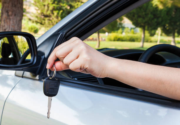 istock Woman's handing the ignition key. 1126738737