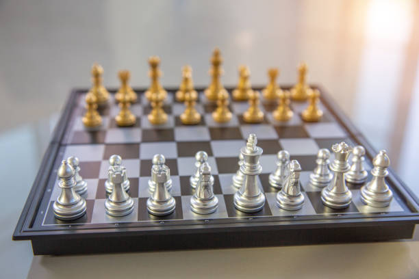 istock Gold chess game face with the another silver team background .Concept strategy 1126738755