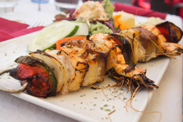 Mixed fish skewer with cod fish, tuna, prawns, scallops and vegetables prepared on bbq Delicious seafood dish from traditional Madeira island cuisine madeira sauce stock pictures, royalty-free photos & images