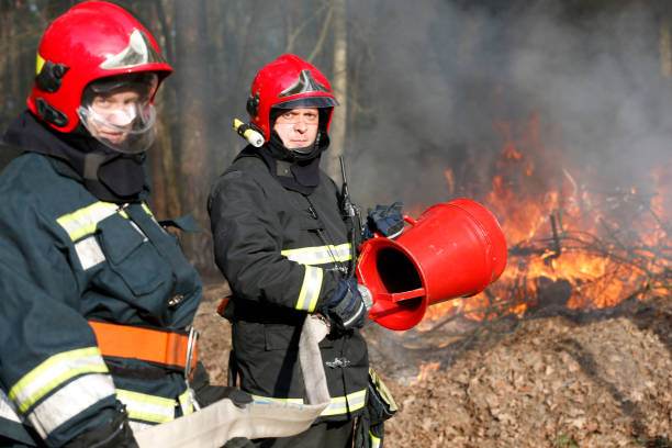 istock Firefighters preparing to extinguish forest fire.Extinguish the fire. Work firefighter. Fight with fire. Dangerous profession 1126744492