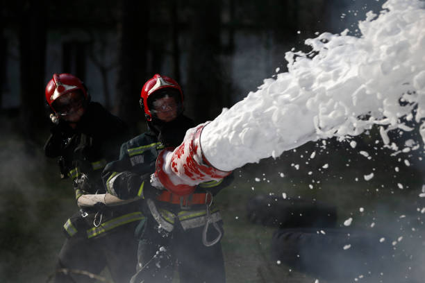 istock .Extinguishing the fire. Firemen are working. Fill the foam with a fire. Resolute firefighters. Fight fire. 1126744554