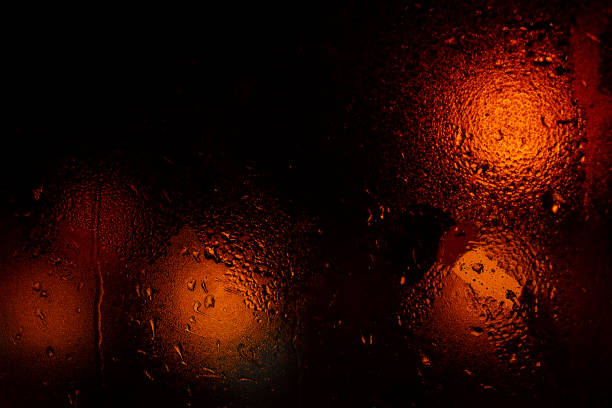 istock Night colorful big city lights through car windshield.Light are defocused and blurred. Focus on windshield. Underexposed photo. 1126745726
