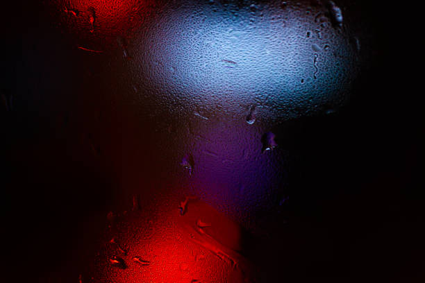 istock Night colorful big city lights through car windshield.
Light are defocused and blurred. Focus on windshield. Underexposed photo. 1126745728