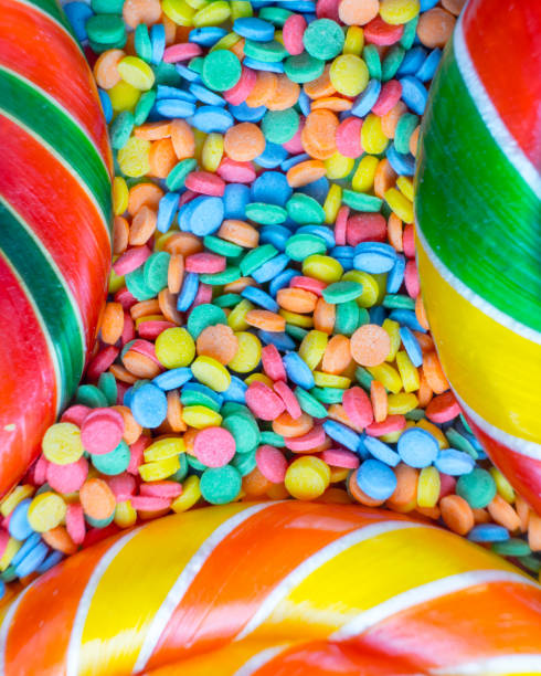 background from multicolored assortment of delicious candy and confetti top view
