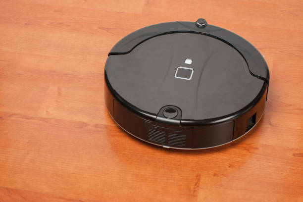 istock robotic vacuum cleaner working on laminate wood floor. smart cleaning technology housekeeping 1126748031