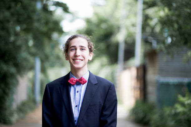 Portrait of a teenager smiling and wearing a suit for his prom night suit, graduation, One Boy Only, People, Smiling bow tie photos stock pictures, royalty-free photos & images