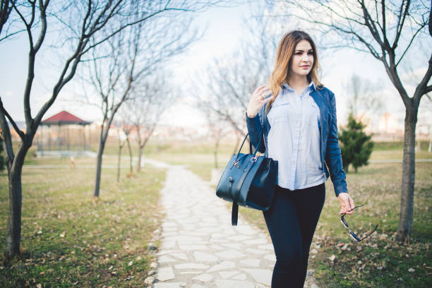 istock Young woman walking  in park . 1126749085