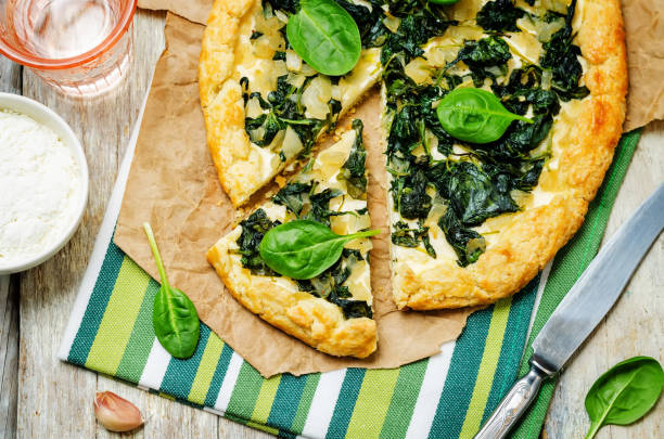 istock Spinach Ricotta Galette with fresh spinach leaves 1126749253