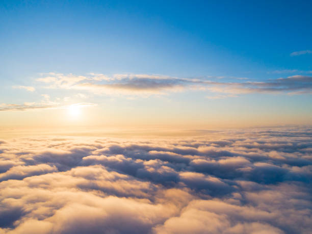 Aerial view White clouds in blue sky. Top view. View from drone. Aerial bird's eye view. Aerial top view cloudscape. Texture of clouds. View from above. Sunrise or sunset over clouds Aerial view White clouds in blue sky. Top view. View from drone. Aerial bird's eye view. Aerial top view cloudscape. Texture of clouds. View from above. Sunrise or sunset over clouds stratosphere airplane cloudscape mountain stock pictures, royalty-free photos & images