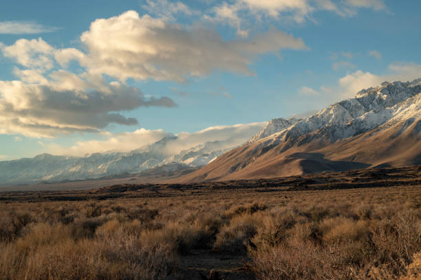 istock cloudy morning sky above snowy mountain peaks 1126750081