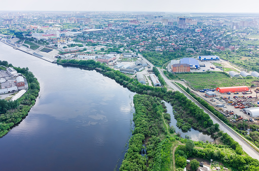 Tyumen, Russia - June 3, 2015: Communist street along Tura river. Tyumen state architectural and construction university, quay and Holy Trinity Monastery