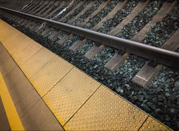 istock Close Up View of Train Tracks and Passenger Platform 1126750553
