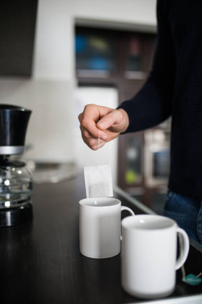 istock Handsome man drinking tea at home in the kitchen. 1126752373