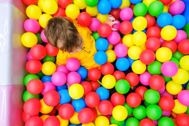 istock kid play ball pool fun playground happy 1126752489