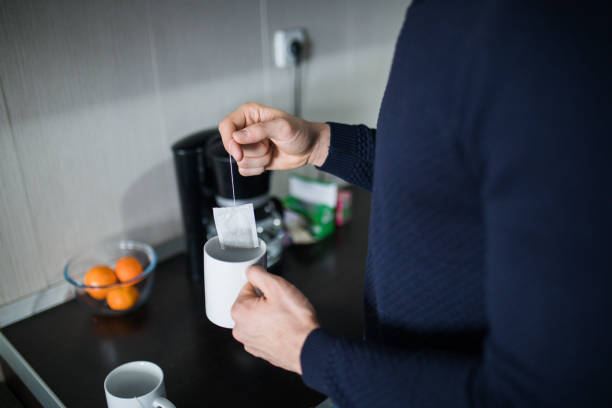 istock Handsome man drinking tea at home in the kitchen. 1126752530