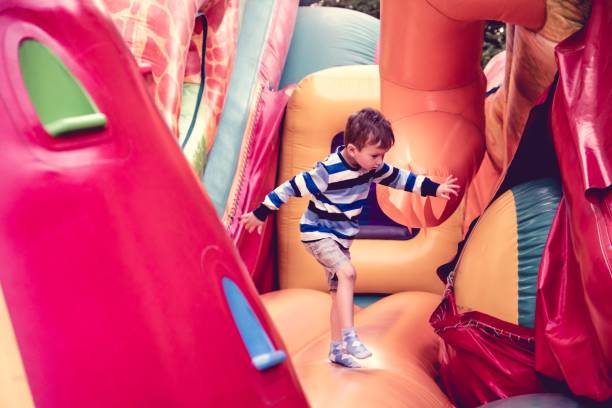 istock trampoline boy child slide childhood fun castle 1126752531