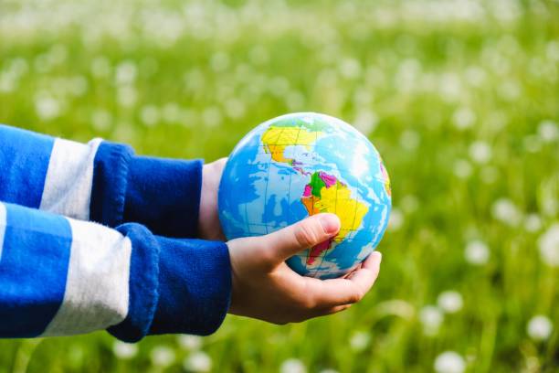 istock concept earth grass green lawn environment hand 1126752544