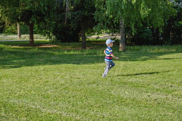 istock happy child fun kid summer. grass. 1126753101