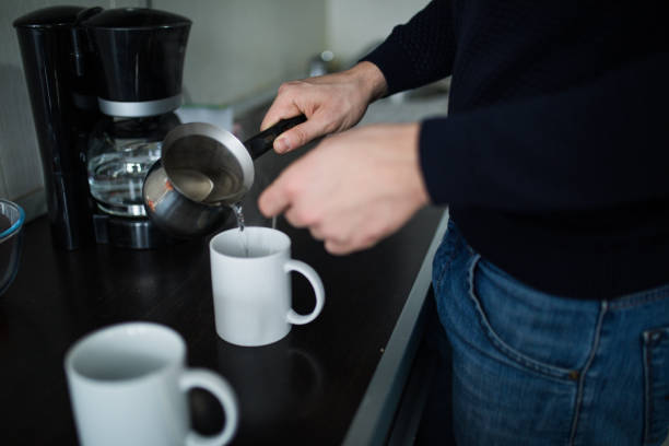 istock Handsome man drinking tea at home in the kitchen. 1126753444