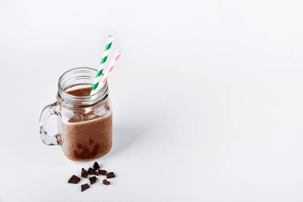 istock Protein shake, smoothie with chocolate and cocoa in a jar on a white background 1126753591