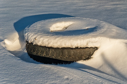 Old Car Tire Under the Snow