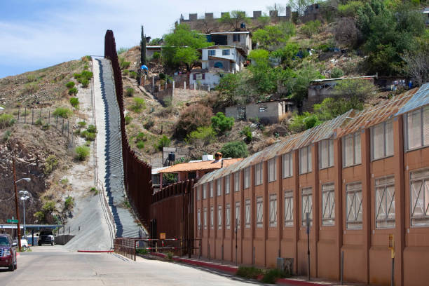 United States Border Wall with Mexico in Nogales Arizona United States border wall with Nogales Mexico neighborhood on the right nogales arizona stock pictures, royalty-free photos & images