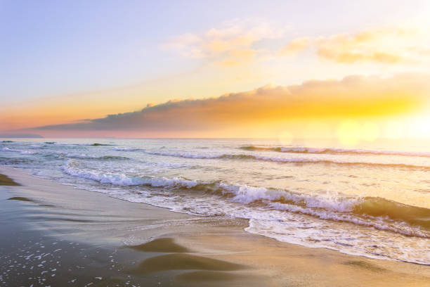 istock Waves on the sea before sunset, the sun shines in the clouds. 1126753899