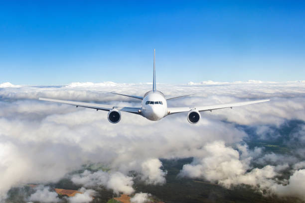 istock Airplane flying in the clouds. Front view aircraft. 1126753975