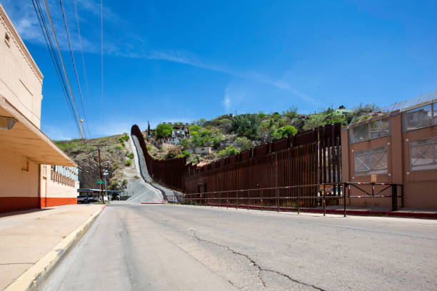 United States Border Wall with Mexico at Nogales Arizona United States border wall with Nogales Mexico behind on the right nogales arizona stock pictures, royalty-free photos & images