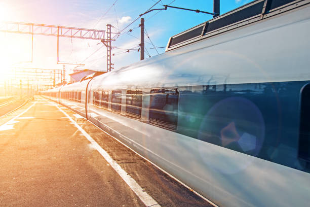 istock Passenger railway carriage train on railroad station at sunset 1126770788