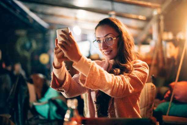 istock Smiling girl texting in cafe 1126771913
