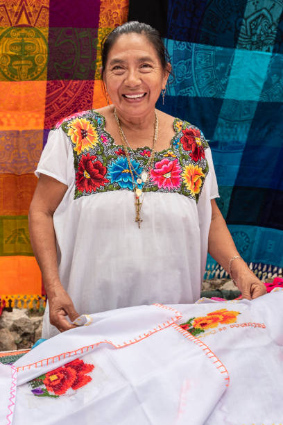 Portrait of a Mayan woman in Yucatan. Tailor specializing in embroidery clothing mayan stock pictures, royalty-free photos & images