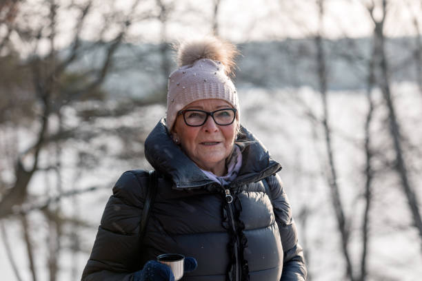 istock Senior lady drinking coffee outdoors 1126776777