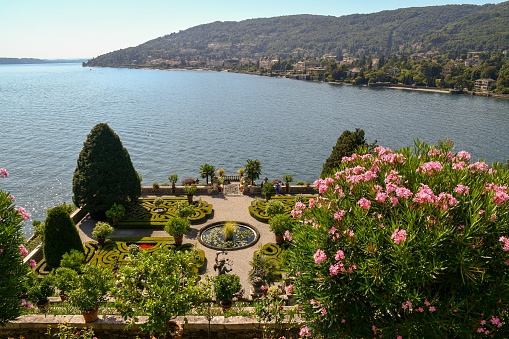 Isola Bella / Italy - July 30 2018: Panoramic view of Lake Maggiore from a beautiful garden in bloom